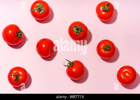 Pattern with cherry tomatoes on pink background Stock Photo
