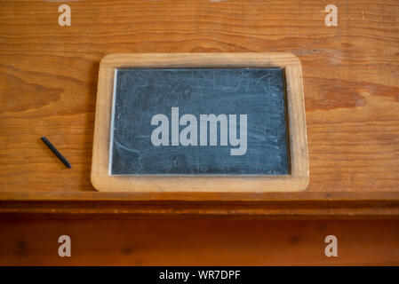Back to School Background Image of Slate Chalkboard on Wooden Desk With Copy Space Stock Photo