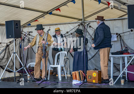 Great Yarmouth, Norfolk, UK – September 08 2019. A folk band made up of one lady and three men having a final warm up before their performance at the Stock Photo