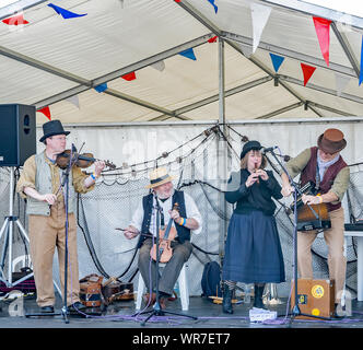 Great Yarmouth, Norfolk, UK – September 08 2019. A folk band made up of one lady and three men during a performance at the Great Yarmouth Maritime Fes Stock Photo