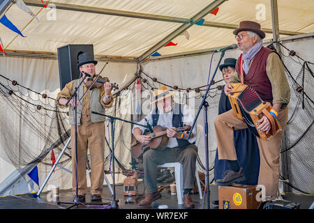 Great Yarmouth, Norfolk, UK – September 08 2019. A folk band made up of one lady and three men during a performance at the Great Yarmouth Maritime Fes Stock Photo