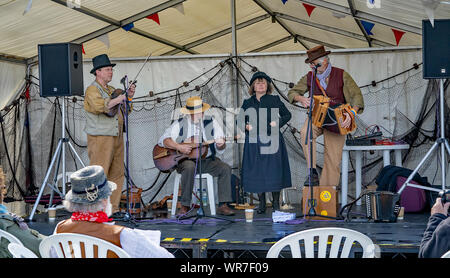 Great Yarmouth, Norfolk, UK – September 08 2019. A folk band made up of one lady and three men during a performance at the Great Yarmouth Maritime Fes Stock Photo