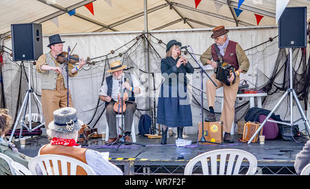 Great Yarmouth, Norfolk, UK – September 08 2019. A folk band made up of one lady and three men during a performance at the Great Yarmouth Maritime Fes Stock Photo