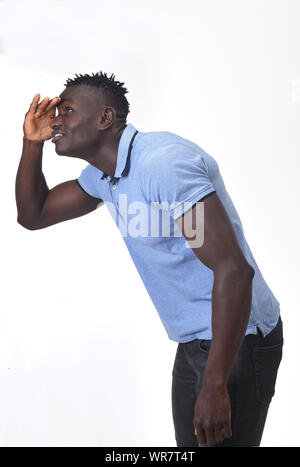 african man with hand in front looking away on white background Stock Photo