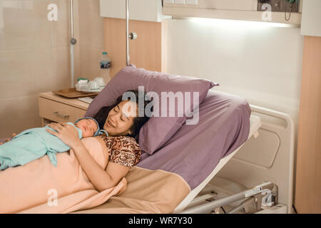 Asian happy mother with newborn baby resting Stock Photo
