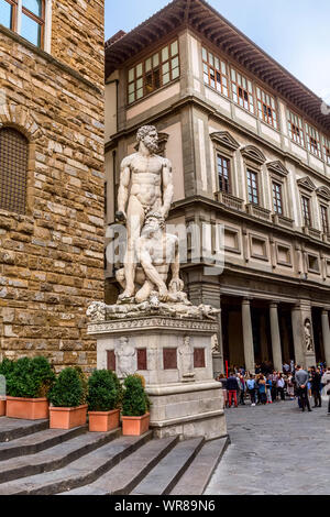 Florence, Italy - October 24, 2018: Hercules and Cacus statue in front of the Palazzo Vecchio on the Piazza della Signoria and people near Uffizi Gall Stock Photo