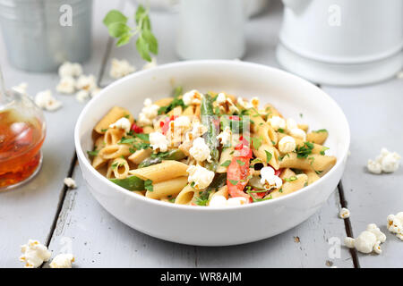 Penne  pasta with asparagus, smoked tofu, chilli peppers and mini corn onions in nut sauce