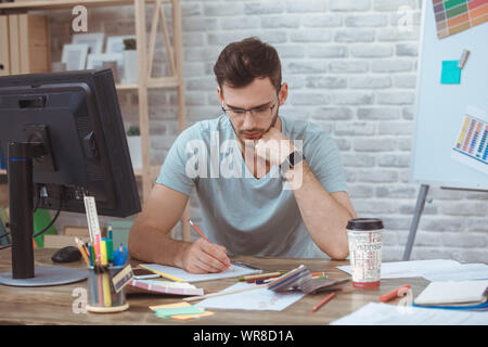 Graphic designer small business home office concept taking notes Stock Photo