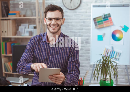 Graphic designer small business home office concept holding digital tablet Stock Photo