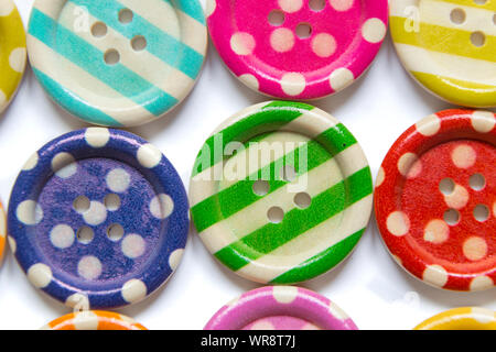 Full frame photo of various colorful sewing buttons on white background. High angle view Stock Photo