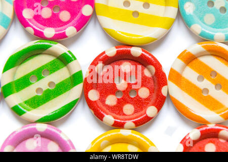 Full frame photo of various colorful sewing buttons on white background. High angle view Stock Photo