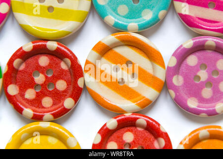 Full frame photo of various colorful sewing buttons on white background. High angle view Stock Photo