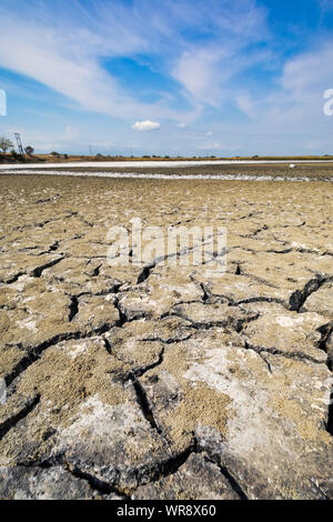 Dry lake bed with natural texture of cracked clay in perspective floor. Death Valley field . background. Selective focus on black soil dark land. Idea Stock Photo