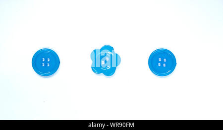 Three Various blue sewing buttons isolated on background. Stock Photo