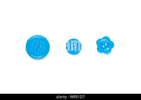 Three Various blue sewing buttons isolated on background. Stock Photo
