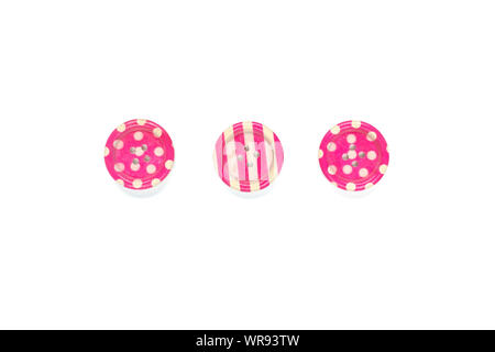 Three Various pink sewing buttons isolated on background. Stock Photo