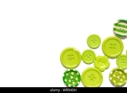 Various green sewing buttons isolated on white background. Stock Photo