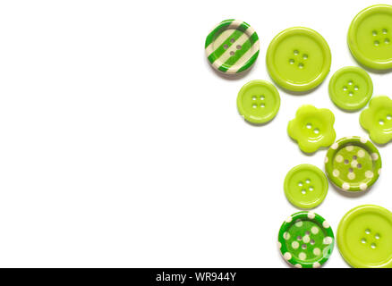 Various green sewing buttons isolated on white background. Stock Photo