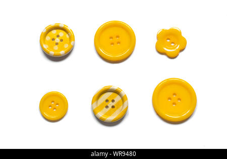 Various yellow sewing buttons isolated on white background. Stock Photo