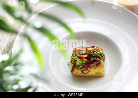 Cauliflower baked in butter with a confit of onions, addition to the soup. Stock Photo