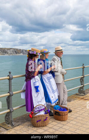 Clog dancers, members of the Beetlecrushers, standing on Swanage Pier at Swanage Folk Festival, Swanage, Dorset UK on a warm sunny day in September Stock Photo