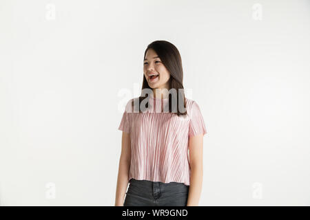 Beautiful female half-length portrait isolated on white studio background. Young emotional woman in casual clothes. Human emotions, facial expression concept. Crazy happy, screaming, laughting. Stock Photo