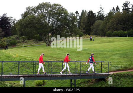 Team USA's (from left to right) Nelly Korda, Jessica Korda and Lexi Thompson walk over a bridge during preview day two of the 2019 Solheim Cup at Gleneagles Golf Club, Auchterarder. Stock Photo