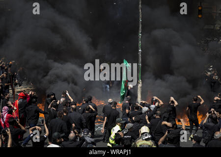 Tehran, Tehran, Iran. 10th Sep, 2019. Iranians burn a tent as they perform at the Ashura ceremonies in Tehran, Iran. The Ashura day commemorates the death anniversary of the third Shiite Imam Hussein, who was the grandson of Muslim Prophet Muhammed. Ashura is the peak of ten days of mourning when Shiite Muslims mourn the killing of Imam Hussein whose shrine is in Karbala in southern Iraq. Credit: Rouzbeh Fouladi/ZUMA Wire/Alamy Live News Stock Photo