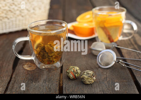 Green flowering tea. A green tea flower is brewed in a transparent glass. Stock Photo