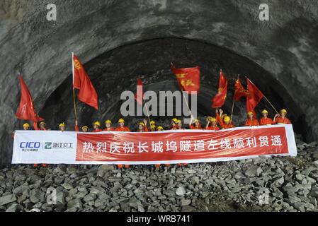 Chinese construction workers celebrate after the left route of the Changchengwu Tunnel broke through in Huzhou City, east China's Zhejiang Province, J Stock Photo