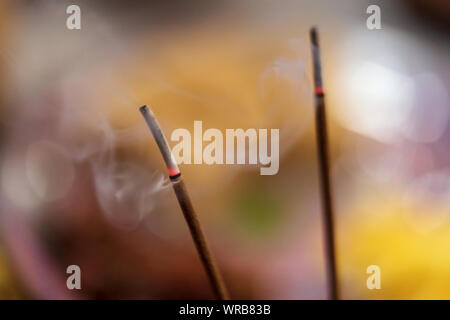 Burning aromatic incense sticks background picture with space for text. Incense for praying Hindu or Buddha gods to show respect. Stock Photo