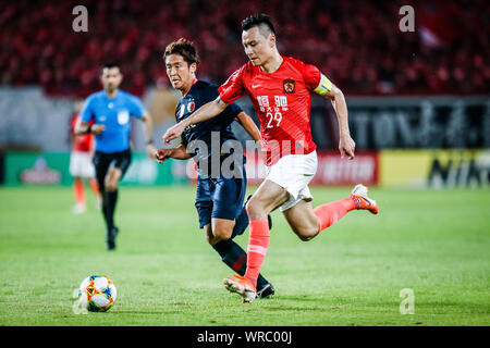 Gao Lin, right, of China's Guangzhou Evergrande challenges Ryota Nagaki of Japan's Kashima Antlers during their first match of the AFC Champoins Leagu Stock Photo