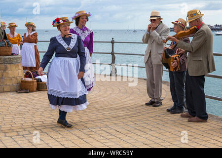Female clog dancers, members of the Beetlecrushers perform on Swanage Pier at Swanage Folk Festival, Swanage, Dorset UK on warm sunny day in September Stock Photo
