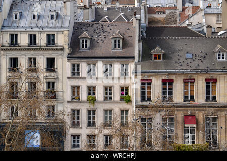 PARIS, FRANCE - MARCH 19, 2014: view of typical parisian building facades taken from the Pompidou Centre in the Beaubourg area. Stock Photo