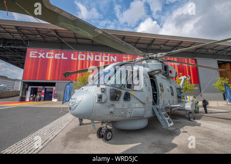 ExCel, London, UK. 10th September 2019. Defence & Security Equipment International (DSEI) event opens from 10th-13th September with over 1600 worldwide exhibitors and more than 35,000 attendees expected. Image: Royal Navy Merlin submarine hunter helicopter at DSEI eastn entrance. Credit: Malcolm Park/Alamy Live News. Stock Photo