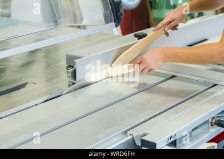 female carpenter on circular saw saw wood workshop sawing in the workshop Stock Photo