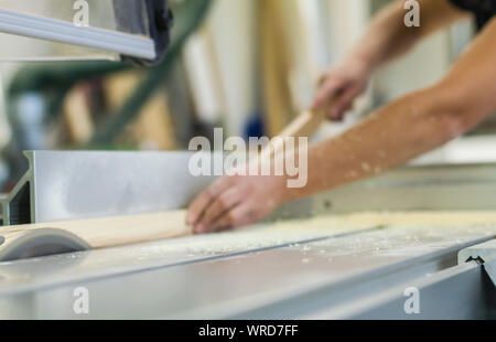 female carpenter on circular saw saw wood workshop sawing in the workshop Stock Photo