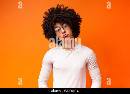 Funny upset african guy pouting lips, looking offended Stock Photo