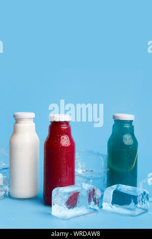 Close up of three different types detox drinks on blue Stock Photo