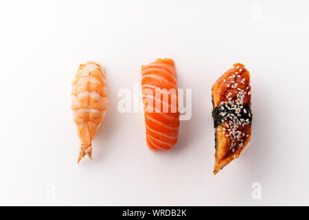 Creative layout with various sushi on white background. Shrimp, eel, salmon. Stock Photo