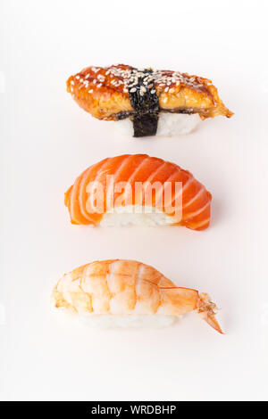 Creative layout with various sushi on white background. Shrimp, eel, salmon. Stock Photo