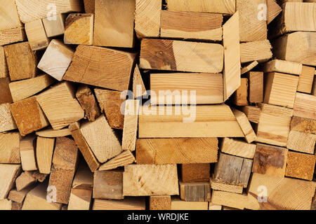 Wall made of pieces of wood, wood storage, wood wall different woods end grain wood firewood Stock Photo