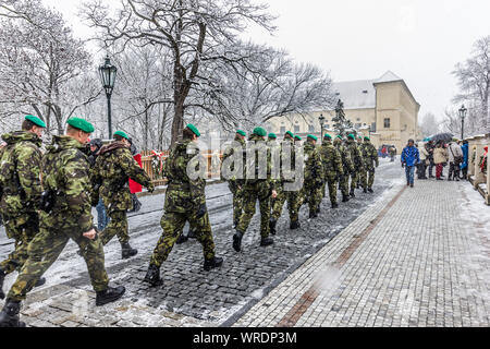 Army soldiers wearing camouflage uniform marching in the snow, Prague Castle, Prague, Czech Republic. Stock Photo