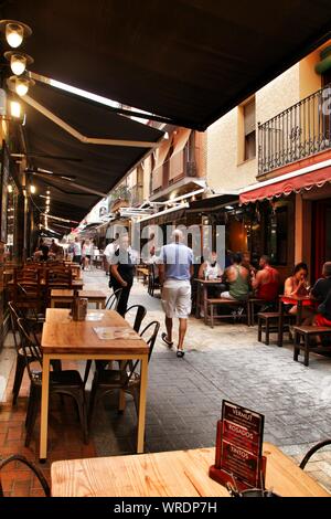 Benidorm, Alicante, Spain- September 7, 2019: Bar of typical spanish food full of people in the old town of Benidorm Stock Photo