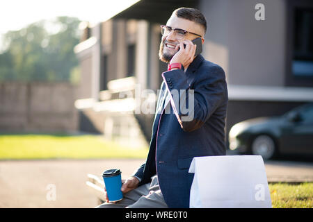 Cheerful man feeling happy receiving call from old friend Stock Photo