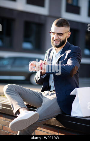 Businessman using his smart watch while checking notifications Stock Photo