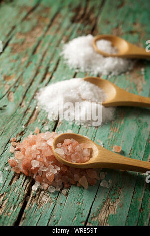 Himalayan salt, fine salt and coarse salt on a wooden table. Stock Photo