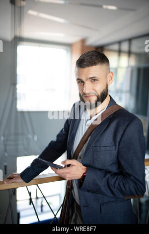 Office worker enjoying little break and texting girlfriend Stock Photo