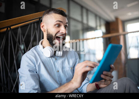Man feeling emotional after reading message from old friend Stock Photo