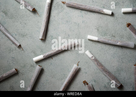 Hand rolling tobacco on a stone table Stock Photo
